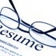 A pair of glasses sitting on top of a resume